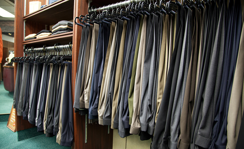 Mens dress pants hanging on a rack